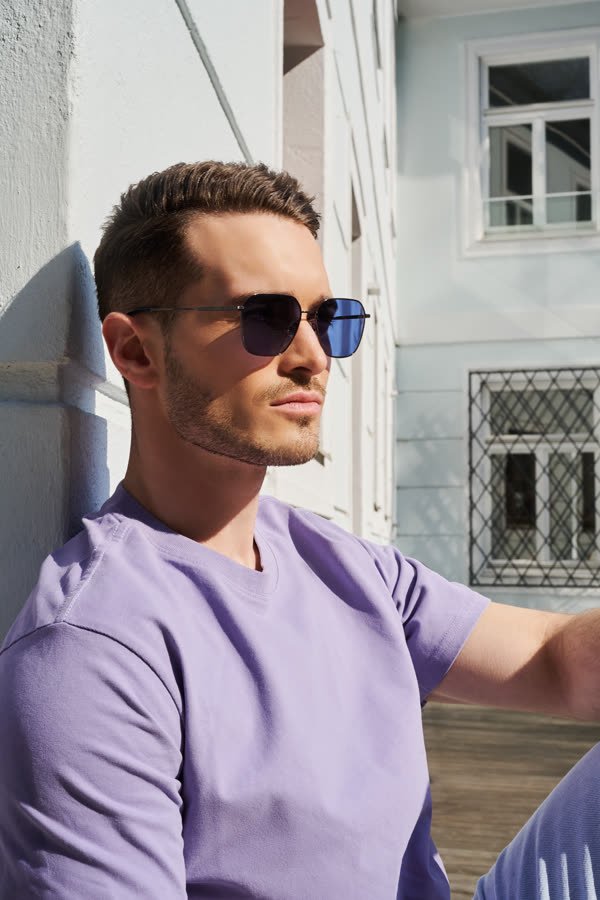 Andreas Schmid, lilac T-shirt and blue sunglasses
