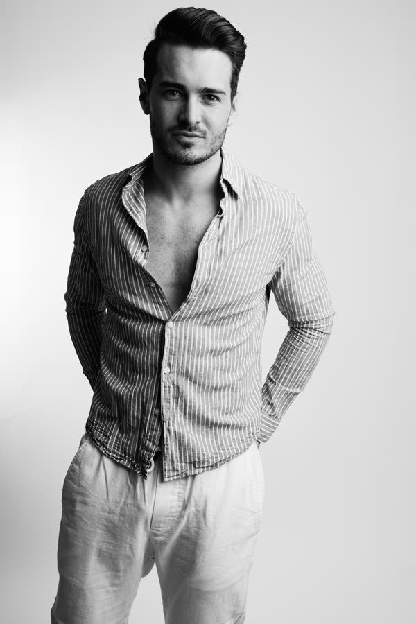 Andreas Schmid, black and white studio photo in a striped shirt