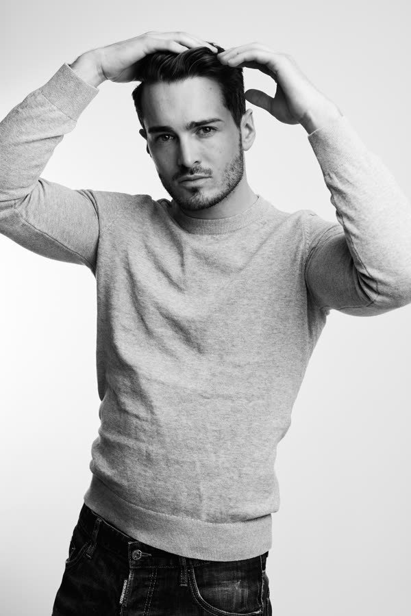 Andreas Schmid, black and white studio photo in a sweater
