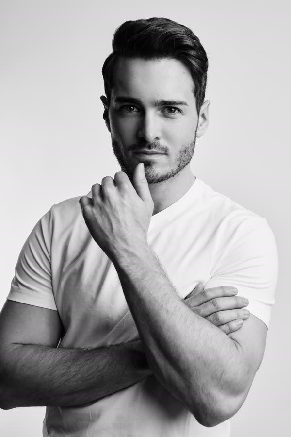 Andreas Schmid, black and white studio photo, hand to chin